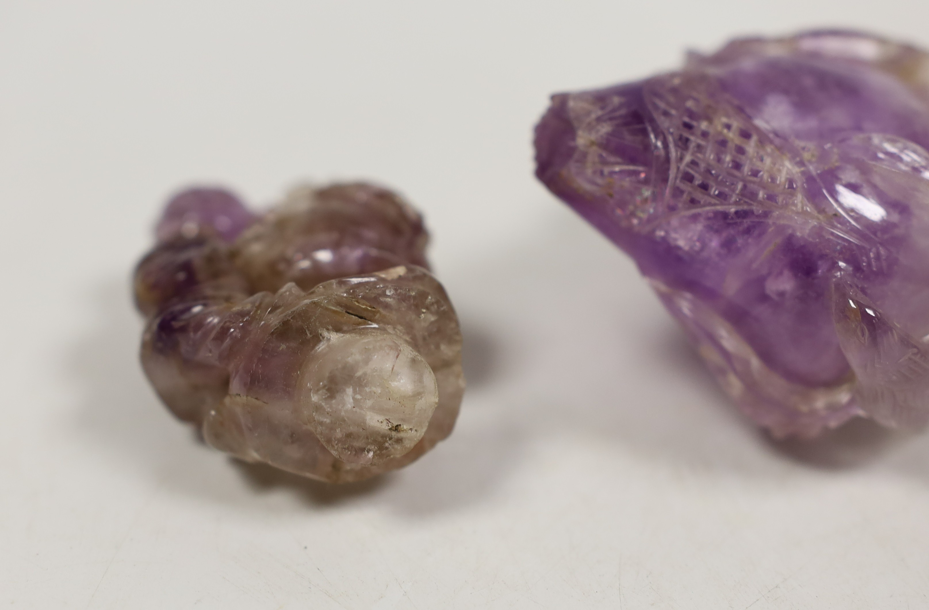 Two Chinese amethyst crystal carvings of peaches and a vase, tallest 8.5 cm